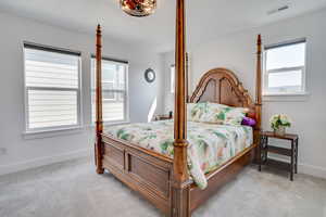 Bedroom with light colored carpet