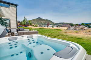 View of patio / terrace with a mountain view and a hot tub