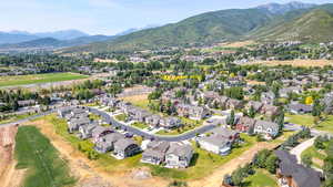 Aerial overview of property's location featuring nearby suburban area and a mountainous background