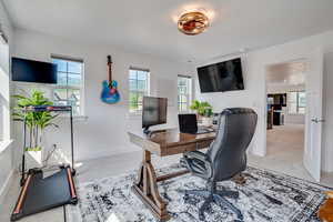 Carpeted office space featuring baseboards