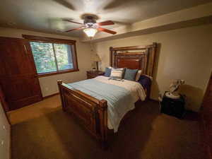 Bedroom with light carpet and ceiling fan