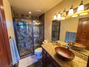 Bathroom featuring vanity and a stall shower