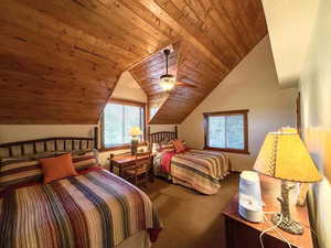 Carpeted bedroom with wooden ceiling, lofted ceiling, and a ceiling fan