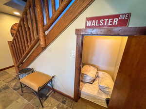 Stairs with stone finish flooring and recessed lighting