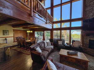 Living area with wood finished floors and a stone fireplace
