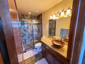 Bathroom featuring vanity, a stall shower, and recessed lighting