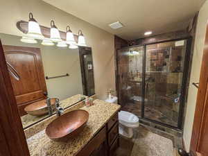 Bathroom with vanity and a shower stall