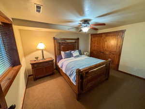 Bedroom featuring light colored carpet and a ceiling fan