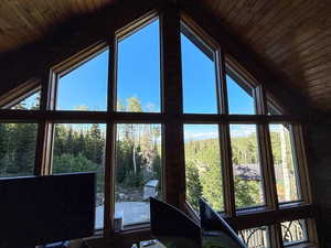Sunroom featuring vaulted ceiling
