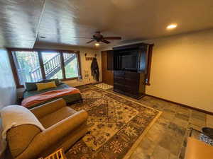 Living area with a ceiling fan and recessed lighting