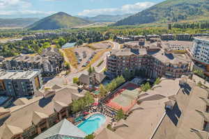 Drone / aerial view of a mountain backdrop and a pool