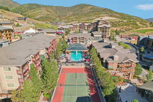 Aerial perspective of suburban area with a pool and a mountainous background