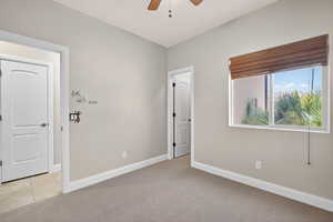 Unfurnished room with light carpet and a ceiling fan