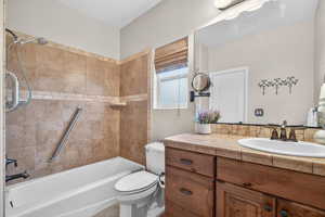 Bathroom featuring vanity and shower / tub combination