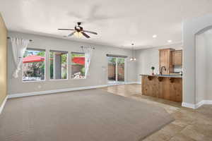 Unfurnished living room featuring recessed lighting, ceiling fan, and light tile patterned floors