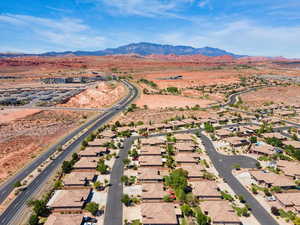 Aerial overview of property's location featuring a mountain backdrop and nearby suburban area