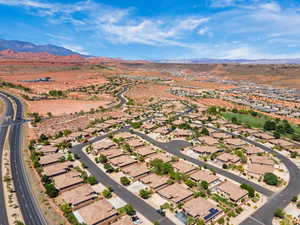 View of property location featuring mountains and nearby suburban area