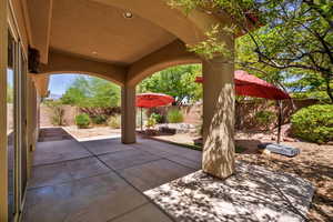 Fenced backyard with a patio