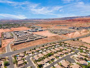 Aerial overview of property's location featuring a mountainous background and nearby suburban area