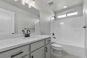 Bathroom featuring vanity,  shower combination, and tile patterned floors