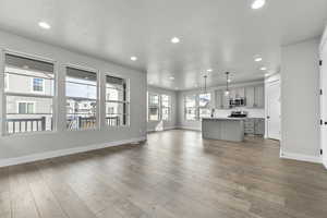 Unfurnished living room with recessed lighting and wood finished floors