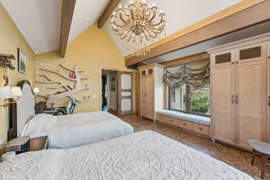 Bedroom with beamed ceiling, high vaulted ceiling, and a chandelier