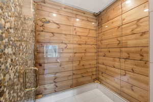 Full bath featuring a shower stall and tile patterned floors