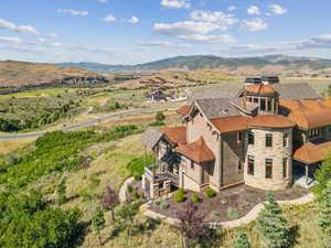 Aerial view of property and surrounding area with mountains