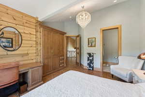 Bedroom featuring log walls, a chandelier, recessed lighting, and high vaulted ceiling