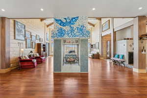 Lobby with wooden walls, high vaulted ceiling, and beamed ceiling