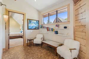 Living area featuring healthy amount of natural light, lofted ceiling, recessed lighting, and tile patterned floors