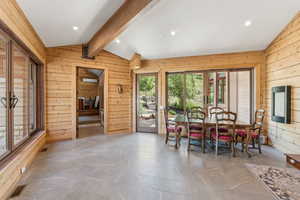 Dining room with wood walls and recessed lighting