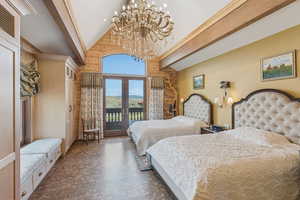 Bedroom with access to outside, french doors, high vaulted ceiling, a mountain view, and a chandelier