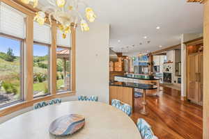 Dining space featuring dark wood-style floors, recessed lighting, and a chandelier