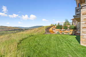 View of grassy yard featuring a mountain view