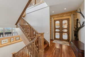 Foyer featuring stairway, french doors, hardwood / wood-style floors, and recessed lighting