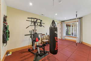 Exercise area with baseboards and recessed lighting