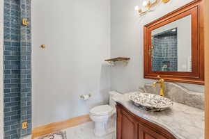Bathroom featuring marble finish flooring and vanity