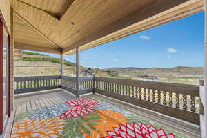 Wooden terrace featuring a mountain view