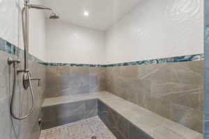 Bathroom featuring a tile shower and recessed lighting