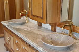 Bathroom with vanity and backsplash