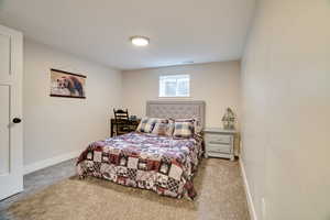 Carpeted bedroom featuring baseboards