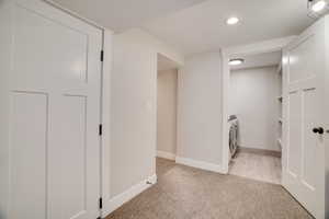 Corridor featuring light carpet and recessed lighting