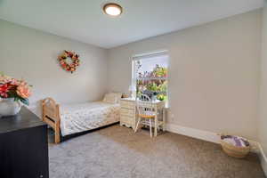 Carpeted bedroom featuring baseboards