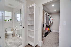 Spacious closet with carpet flooring
