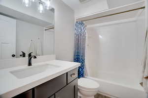 Full bathroom with vanity and shower / bath combination with curtain