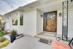 Entrance to property with brick siding