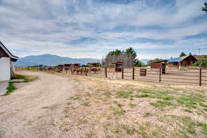 View of yard with a mountain view, an outdoor structure, and an exterior structure