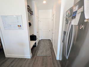 Mudroom with dark wood-style flooring and baseboards