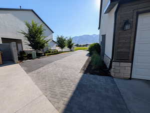 View of side of home with a mountain view